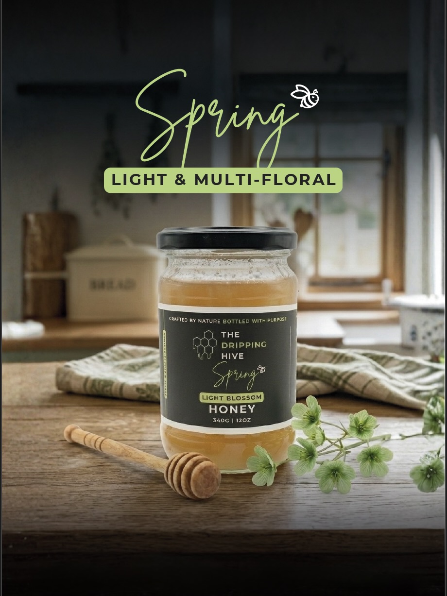 Spring honey jar in a kitchen with a wooden dipper and green hellebore blossoms